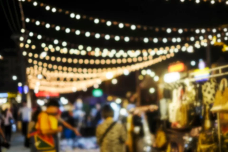 Blurred image of people shopping at night market